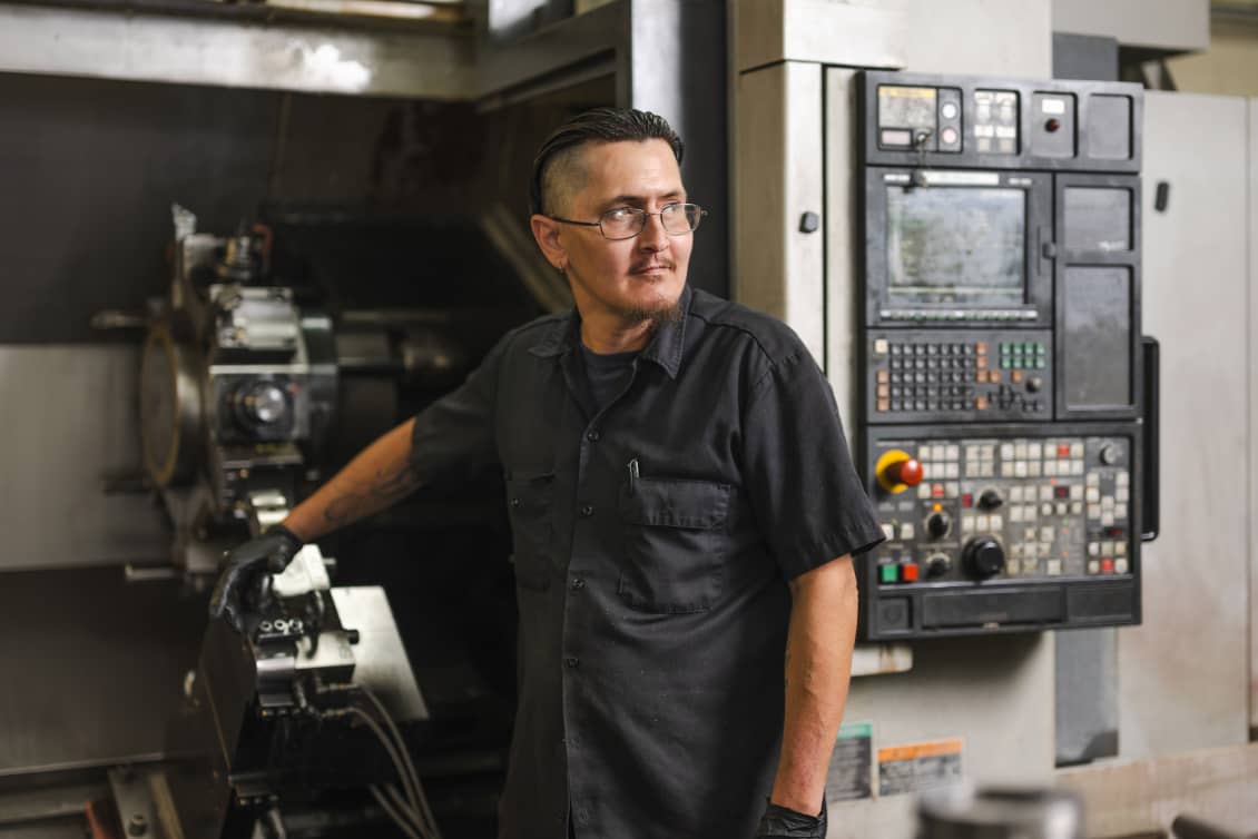A TechTAC employee machining parts for tubing anchors
