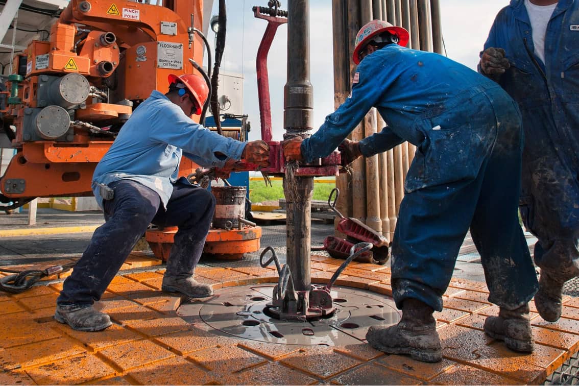 Oilfield workers at a well site