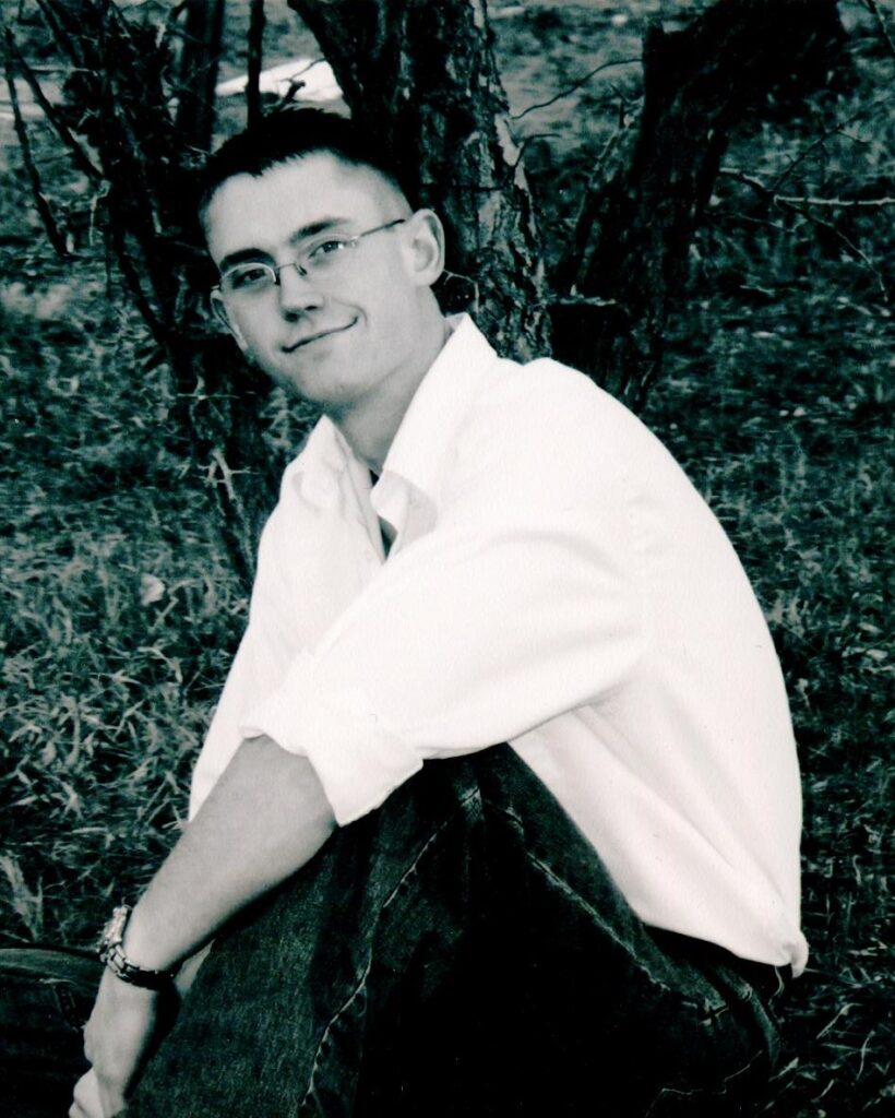 Daniel Averett sitting under a tree looking fly