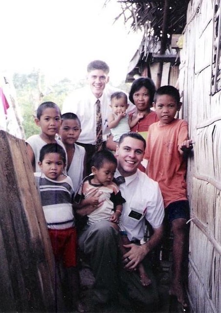 Luke Reary as a missionary surrounded by Filipino children